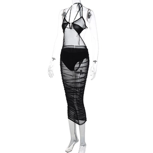 Detail view of black sheer mesh halter dress featuring elegant ruched texture and slim fit