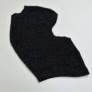 Detail of black knitted balaclava with shimmering rhinestones and mesh texture