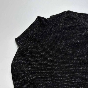 Close-up detail of high neck black bodysuit with shimmering silver rhinestones