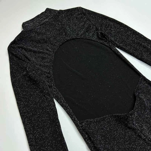 Detail of black glitter fabric with backless cutout and sparkling lurex texture finish