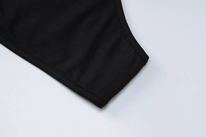 Close-up of black mesh dress fabric texture and professional flatlock edge stitching