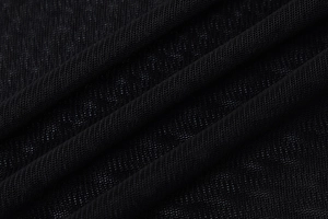 Close-up of black breathable mesh knit fabric texture with fine weave detail