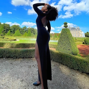 Detailed back view of a slim black evening dress with open back and high side slit
