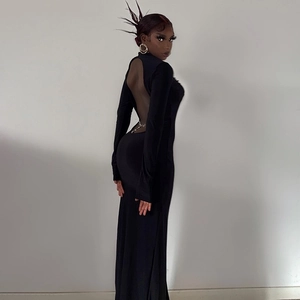 Detail of sexy backless black dress with high neck and decorative silver metal waist chains