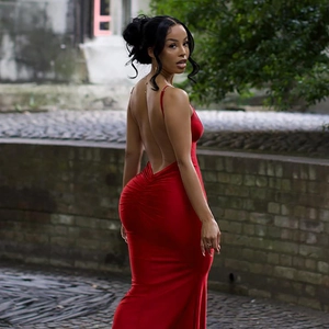Detail view of red backless evening dress with fine straps and ruched mermaid tailoring