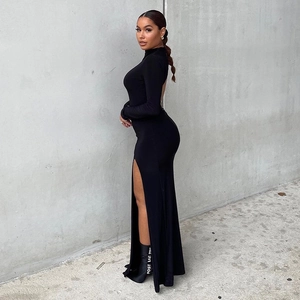 Detail view of the sleek backless design and high side slit on this black midi dress