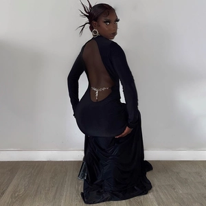 Detail of sexy backless black maxi dress featuring a silver hollow heart chain at the waist