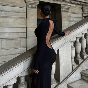 Elegant black backless maxi dress with high slit and decorative metal back chain details
