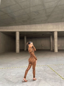 Close-up of leopard print jumpsuit featuring long sleeves and slim fit bodycon design