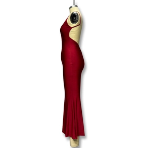 Detail view of the sleek backless design and thin straps on the red fishtail dress