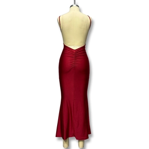 Detail view of the deep red backless dress showing ruched waist and mermaid silhouette