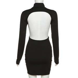 Detail of elegant black long-sleeve dress featuring a bold open-back cut and high neck
