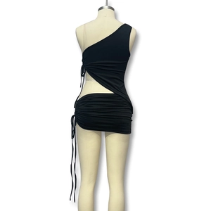 Detail of black one-shoulder dress showing side drawstring and waist cutout design