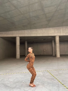 Slim fit long sleeve jumpsuit featuring brown leopard print pattern in urban setting