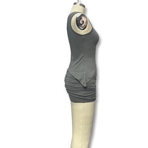 Detail view of grey two-piece set featuring a one-shoulder ruched skirt and cropped top