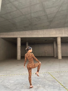 Outdoor shot of long sleeve leopard print bodysuit with slim fit stretch fabric