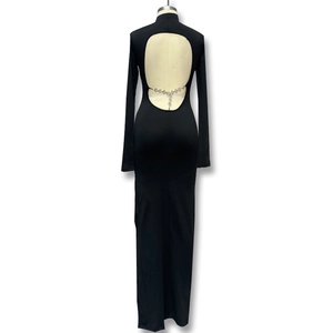 Detail of elegant black backless dress featuring a silver heart chain decoration