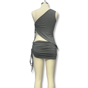 Detailed view of dark grey two-piece set featuring one-shoulder top and ruched mini skirt