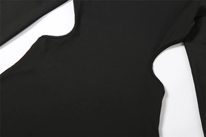 Detail of waist cut-out design on a black bodycon dress with elastic knitted fabric
