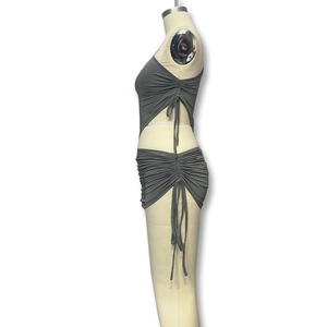 Detail view of grey two-piece knit set with side drawstring ruched mini skirt