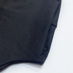 Close-up detail of high-density black knit fabric texture and premium seam stitching