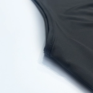 Close-up of the knitted fabric texture and flat seams on a black summer two-piece set