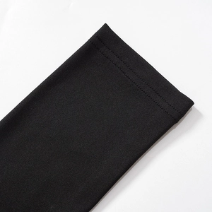 Detailed close-up of double-stitched reinforced hem on black knit evening dress