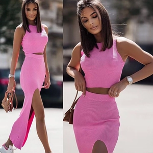 Pink two-piece knit set featuring a slim-fit crop top and high-waist side slit long skirt