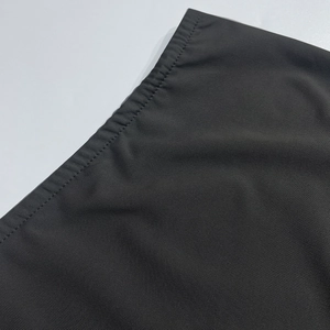 Close-up of black mesh fabric detail with professional double-needle lockstitch seams