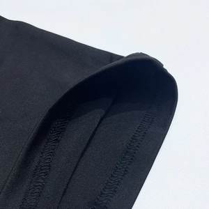 Detail shot of high-quality double-needle stitching on the black dress fabric edge