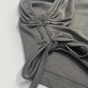 Close-up of side drawstring and ruched texture on charcoal gray skirt set
