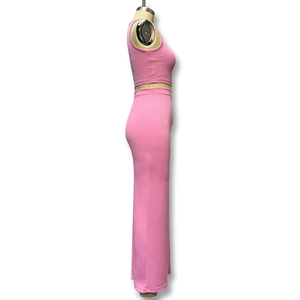 Close-up of pink ribbed knit fabric detail on slim-fit crop top and slit maxi skirt set