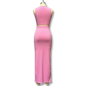 Rear view of a pink two-piece set featuring a cropped tank top and a high-waisted slit skirt