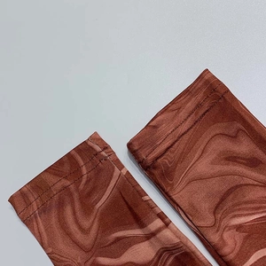 Detail of sleeve cuff with reddish-brown marble print and durable double-stitch seams