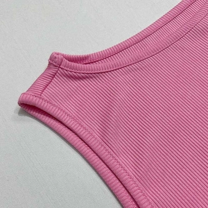 Detail of pink ribbed knit texture and stitching on the neckline of the two-piece set