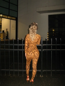Rear view of sleek leopard print long sleeve bodysuit showcasing slim silhouette at night