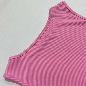 Detail showing high-quality pink ribbed knit fabric texture and durable double-needle stitching