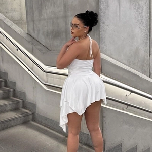Detail of white halter neck mini dress with ruched bodice and asymmetric layered hemline