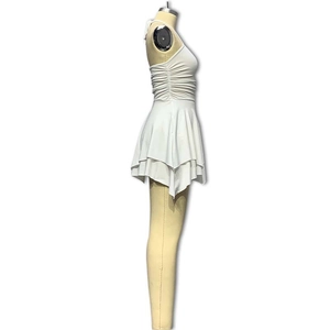 Detail of white halter neck dress featuring pleated waist and irregular layered ruffles