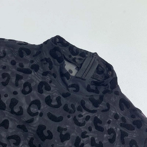 Detail of sheer leopard flocking fabric with high neck and back invisible zipper