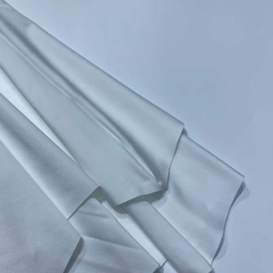Detailed close-up showing the smooth folds and texture of white soft dress fabric