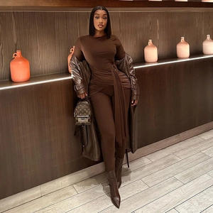 Slim fit long sleeve dark brown jumpsuit with round neck and metallic buckle detail