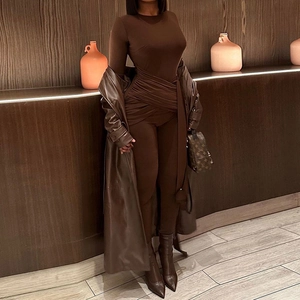 Women's monochrome fashion set featuring a brown bodysuit, leather coat, and high boots