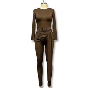 Detail of dark brown bodysuit showing draped waist, metal ring buckle and ribbon ties