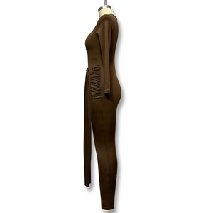 Detailed side view of brown long sleeve bodysuit featuring waist pleats and decorative ties