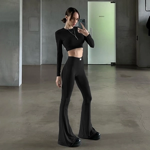 Women's black two-piece set featuring a long sleeve crop top and high waist flared pants