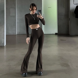 Detail shot of a chocolate brown ribbed knit set featuring high waist flared pants with label