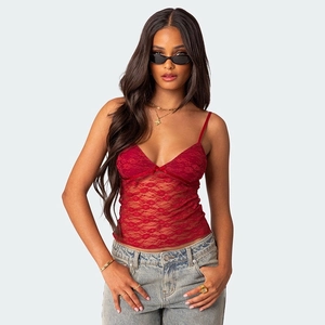 Detail of red lace V-neck camisole featuring a delicate bow and floral sheer texture