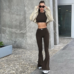 Women's dark brown sports set featuring cropped vest and high-waisted flared pants in street style