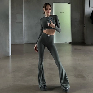 Detail of slim-fit ribbed charcoal grey tracksuit with crop top and flared leggings
